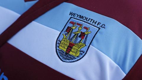 Weymouth FC's crest on a shirt before a game 