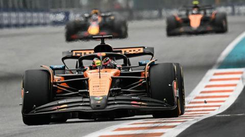 Oscar Piastri leads the Miami Grand Prix with Max Verstappen and Lando Norris fighting over second in the background