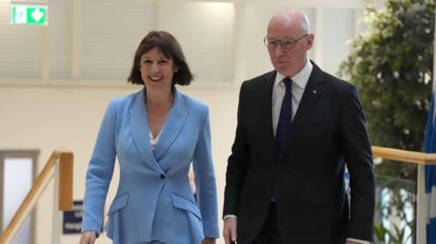 Rachel Reeves and John Swinney walking together. Both are smiling as the Chancellor visited Scotland.