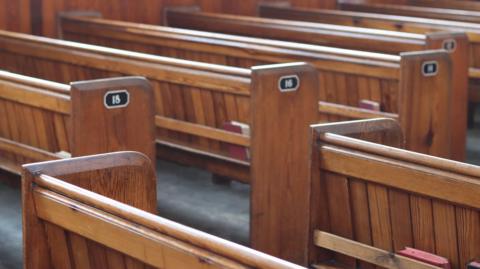 A stock image of wooden church pews.