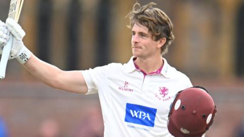 Tom Abell raises his bat after reaching his hundred against Yorkshire