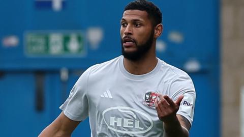 Defender Zak Jules in action for Exeter City