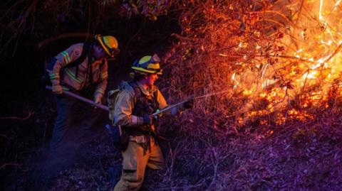 LA firefighters battle a blaze on Sunday