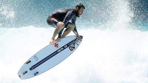 Mikey Wright performs an aerial manoeuvre on a surfboard during the Stab High Sydney in Australia