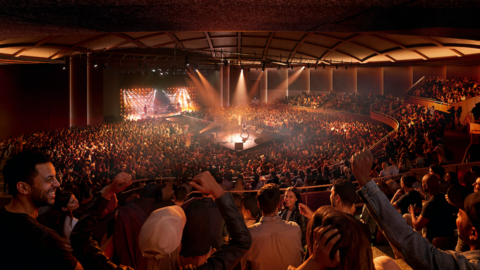 A generated image of a large indoor concert venue filled with a dense crowd surrounding a central stage. Bright stage lights illuminate performers on the stage and cast warm light across the audience. Tiered seating wraps around the space, and many audience members have raised arms. 