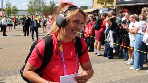 Georgia Evans arrives at the match with a bow in her hair