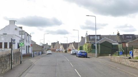 A road with buildings on either side.