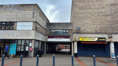 St Matthews Centre and Sports Hall entrance, made of grey brick with blue bollards in front