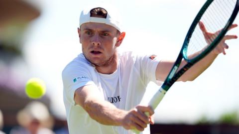Jack Pinnington Jones hits a volley