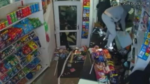 Looters stand on the shop counter pick up items