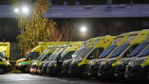 A row of ambulances in a car park