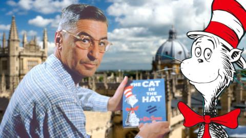 Dr Seuss holding a copy of The Cat in The Hat with a blue cover. He is wearing a blue check shirt and glasses. The Cat in the hat is a cut out cartoon cat figure wearing a red bowtie and a red and white hat. Behind is a blurred photo of the spires of Oxford.