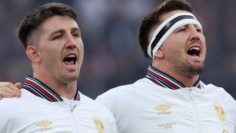 Ben Curry and Tom Curry singing the national anthem