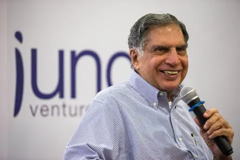 Ratan Tata speaks into a microphone