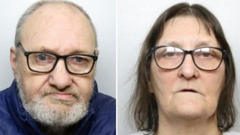 A police mugshot of a 66-year-old man with a grey beard and hair wearing a blue puffa jacket and black glasses, next to a police mugshot of a 64-year old woman with brown hair, a grey pullover and black glasses