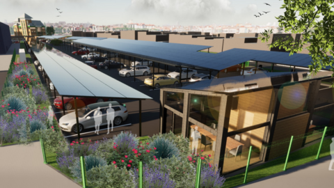 Solar panels stretch out across the car park in the artist's impression. Cars are parked underneath and some people are standing nearby. A city-scape can be seen far off in the distance and some flowers and trees have been planted on the outskirts of the car park.