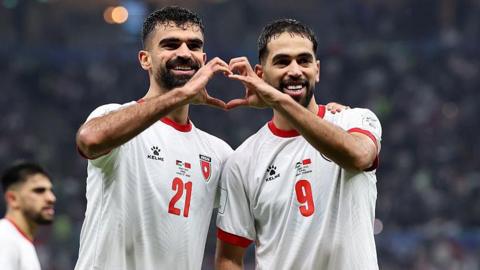 Nizar Al-Rashdan celebrates with his Jordan team-mate Ali Olwan