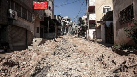 A file photo of the town of Tamoun in the occupied West Bank taken on 7 January, 2025. The image shows rubble and people walking in the distance along a narrow street.