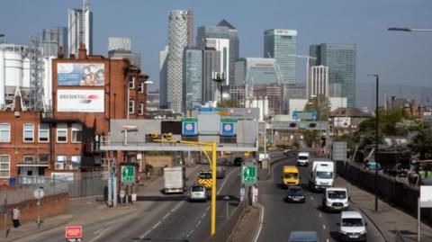 Vehicles drive along the road before they reach the tunnel