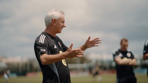 Ian Rush in a black football top gesturing with his hands
