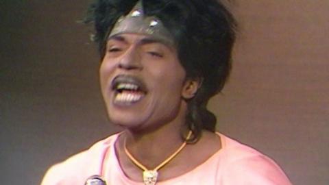 A close up of Little Richard speaking to the interviewer.
