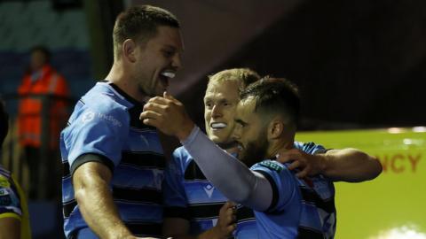 Iwan Stephens celebrates his first competitive try for Cardiff with Aled Davies and Ben Donnell