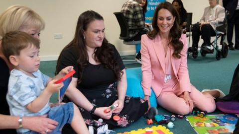 The Princess of Wales sitting on the floor with Kinship Carers and children during a visit to the Saint Pancras Community Association. 