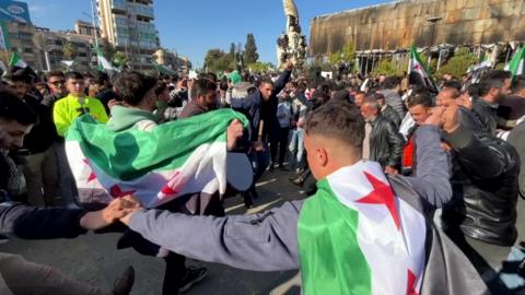 Dancing crowds in Aleppo celebrate end of Assad regime