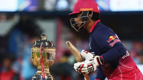 Vaibhav Sooryavanshi walks past the IPL trophy before starting his innings