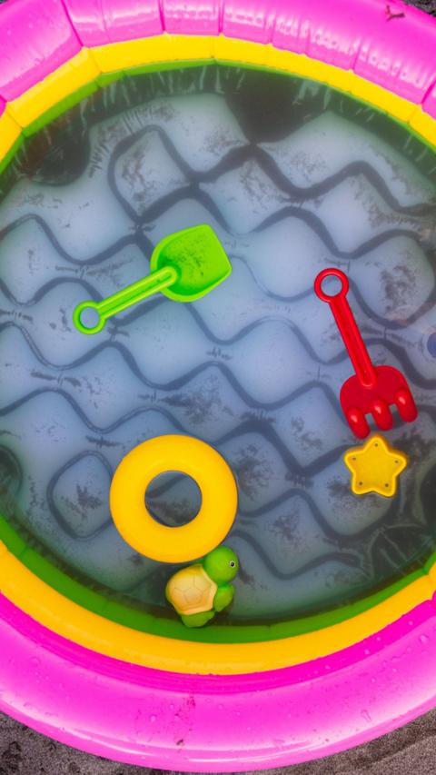 Children toys in a paddling pool.