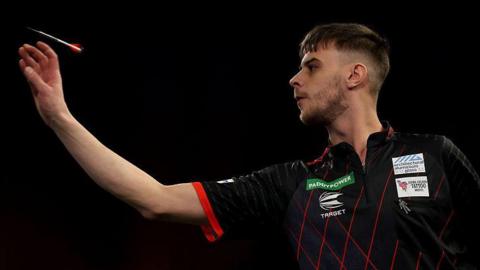 Dom Taylor throws a dart