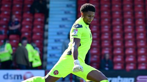 Myles Roberts kicks the ball from the goal area