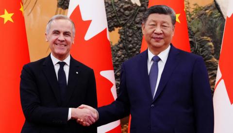 Carney and Xi Jinping shake hands