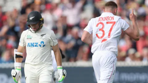 New Zealand captain Tom Latham (left) walks off after being dismissed by England fast bowler Gus Atkinson (right)