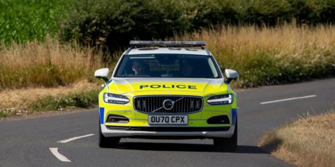 A police car travelling along a road