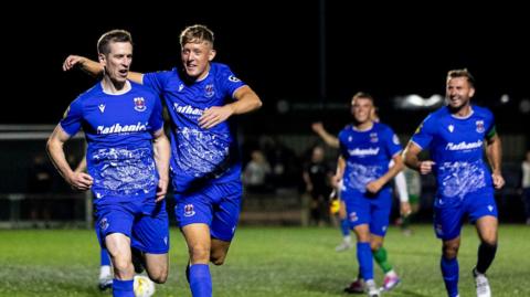 Penybont players celebrate Chris Venables' (L) late goal