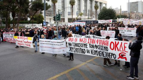 A crowd carrying banners outside the court of Appeals