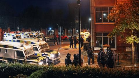 police in riot gear hold a line on Bishop Street in Derry