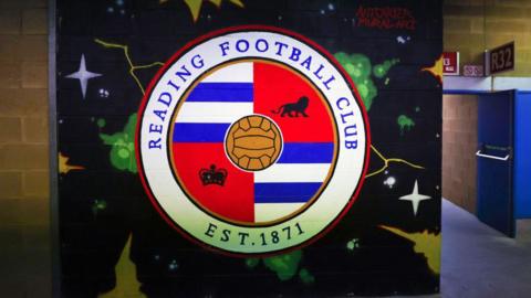 A mural of the Reading club badge on a wall inside the Select Car Leasing Stadium.