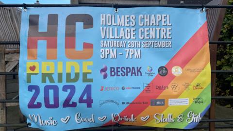 A colourful banner advertising Holmes Chapel Pride on Saturday 28 September at the Village Centre.