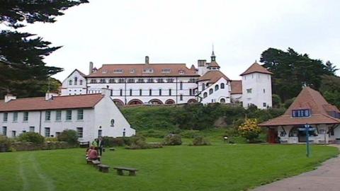 A series of white buildings with big green gardens - this is the monastery on Caldey Island.