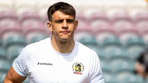 Dafydd Jenkins running on the pitch during a pre-game warm-up for Exeter