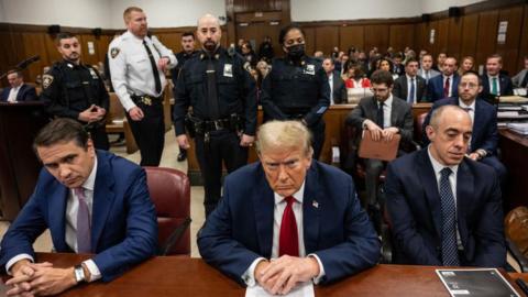 Donald Trump at his New York criminal trial, flanked by attornies Todd Blanche, left, and Emil Bove, right.