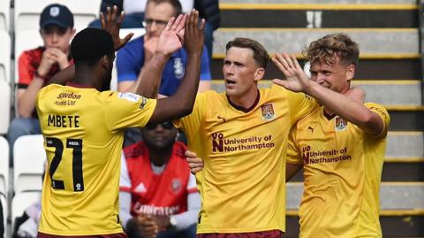 Northampton Town players celebrate at Huddersfield