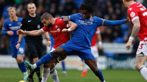 Tunmise Sobowale of Shrewsbury Town in action against Wrexham's Elliot Lee in last season's FA Cup