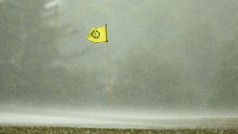 A flag billowing in the wind in heavy rain