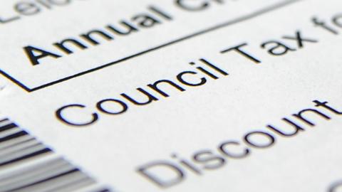 A letter which says council tax and discount. Parts of the letter is blurred. 