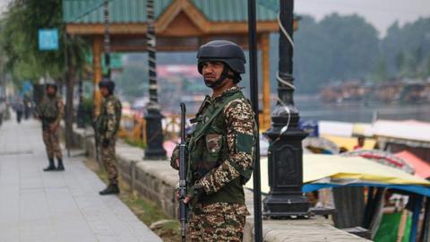 An Indian paramilitary soldier guards along the banks of Dal Lake in Srinagar, Jammu and Kashmir, on May 9, 2025.