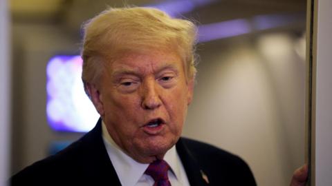 U.S. President Donald Trump talks to members of the media aboard Air Force One en route to Joint Base Andrews, Maryland, U.S., April 17, 2026.