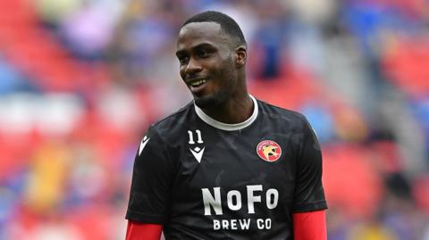 Levi Amantchi warming up ahead of the 2025 League Two play-off final for Walsall